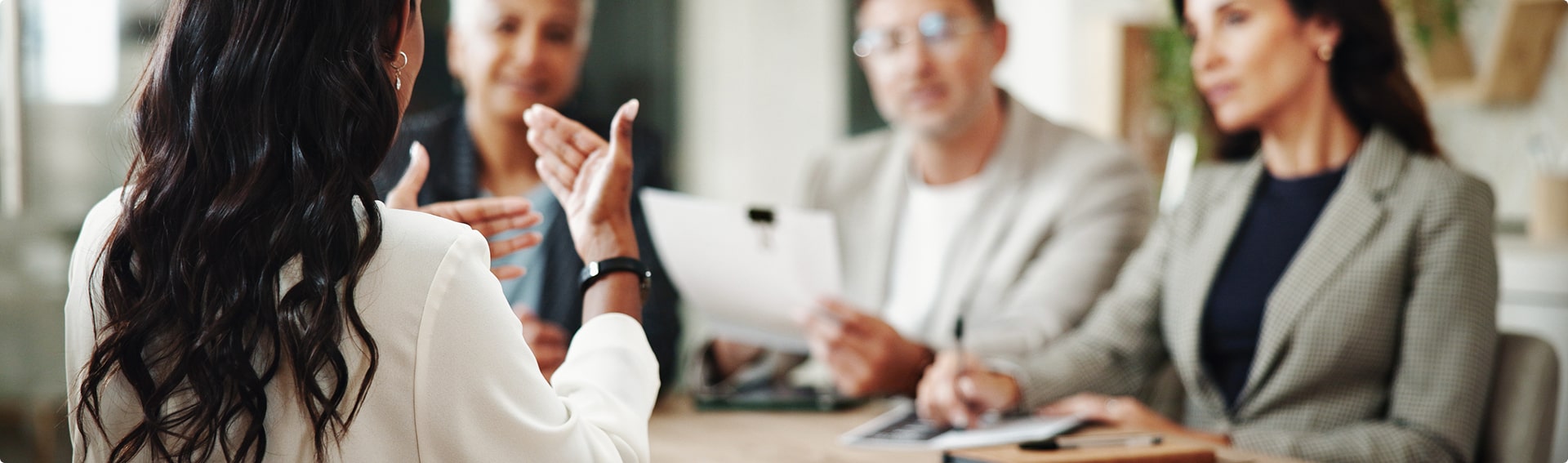 Professional interview panel discussing with a candidate.