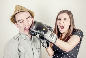 Girl boxing a guy for annoying London offices phrases